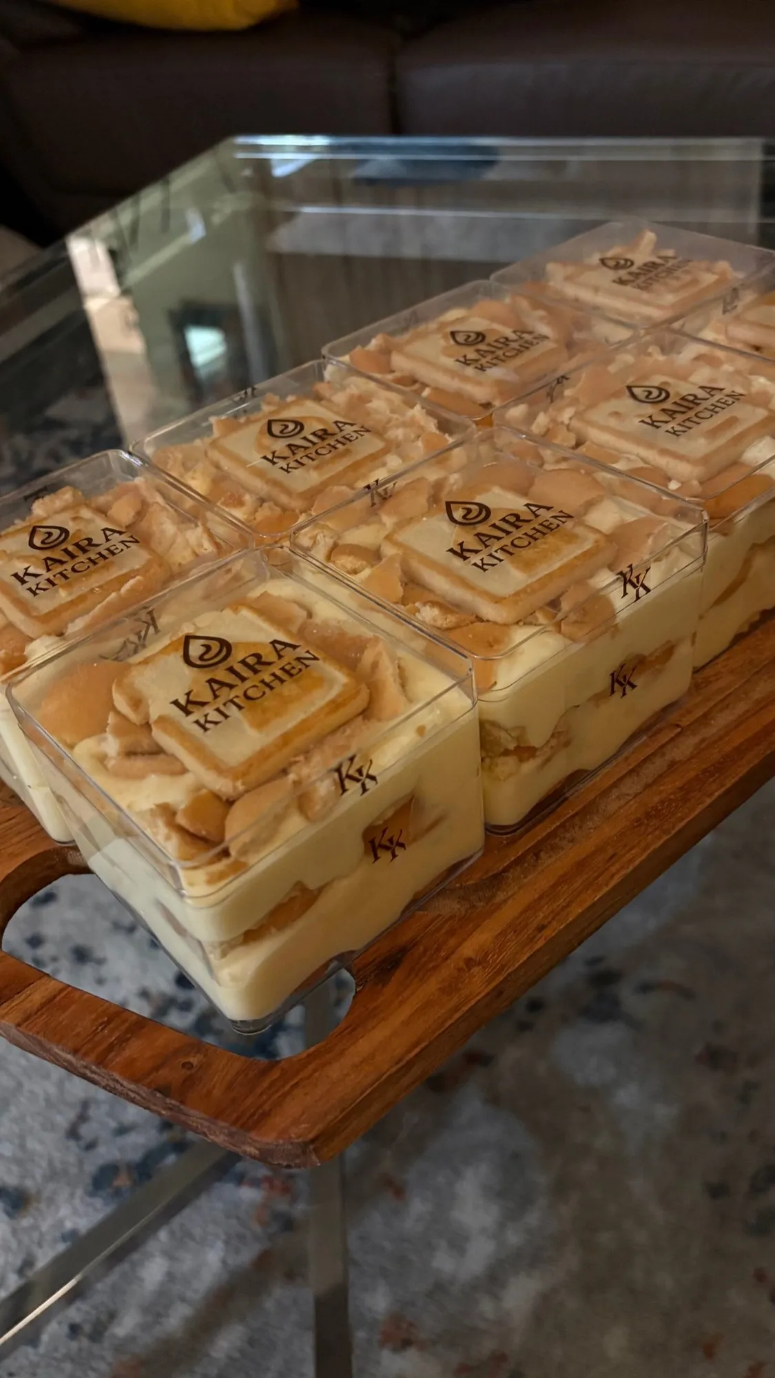 Banana pudding cups with vanilla wafers and branded Kaira Kitchen cookie lids